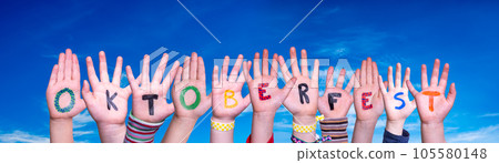Children Hands Building Word Oktoberfest, Blue Sky 105580148