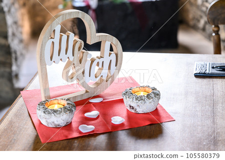 Wedding wood sign LOVE Heart, Text in German YOU and Me for Background photo with candles 105580379