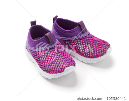 Sports shoes for children on a white background. Pink sneakers with white soles Sports shoes for children on a white background. Pink sneakers with white soles 105580441