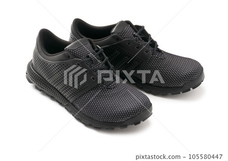 Sporty modern black mesh sneakers with lace-ups. New shoes on a white background 105580447