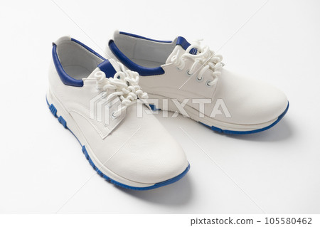 White casual leather lace-up sneakers. A new pair of shoes on a white background. White casual leather lace-up sneakers. A new pair of shoes on a white background. 105580462