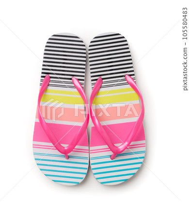 Beach slippers with colorful stripes. A new pair of shoes on a white background. 105580483
