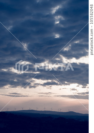 Abstract background sky Dawn Sunset Contrast dark shadow bright cloud sun orange silhouette above the mountains near the sea 105582048