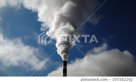 grey smoke from industrial chimney in a blue cloudy sky grey smoke from industrial chimney in a blue cloudy sky 105582292