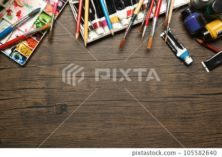 Acrylic paints tubes, pallets and brushes on wooden background with empty space text. Art, education and creativity concept. 105582640
