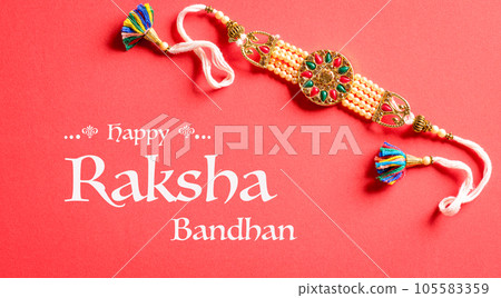 Raksha Bandhan, Indian festival with beautiful Rakhi on red background.  A traditional Indian wrist band which is a symbol of love between Sisters and Brothers. 105583359