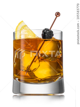 Old fashioned cocktail in homemade glass with ice cubes and blackberry with orange slice on white Old fashioned cocktail in homemade glass with ice cubes and blackberry with orange slice on white 105583770