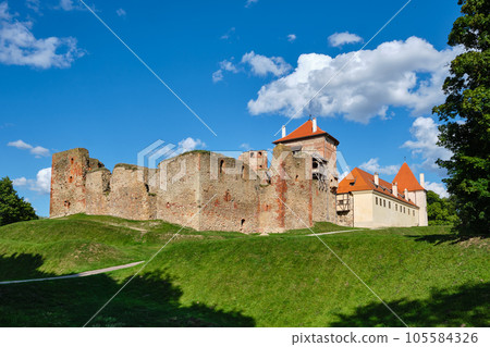 View of Latvian tourist landmark attraction -  ruins of old medieval Bauska castle and the remains of a later palace. Bauska, Latvia. 105584326