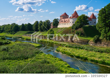 View of Latvian tourist landmark attraction -  ruins of old medieval Bauska castle and the remains of a later palace. Bauska city, Latvia. 105584327