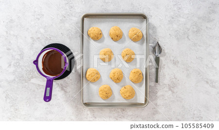 Flat lay. Drizzling melted chocolate over banana cookies. Flat lay. Drizzling melted chocolate over banana cookies. 105585409