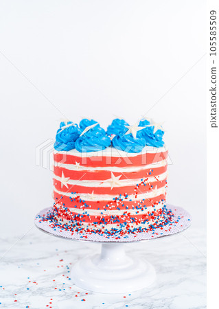 Decorating chocolate cake with white, red, and blue buttercream frosting for July 4th celebration. Decorating chocolate cake with white, red, and blue buttercream frosting for July 4th celebration. 105585509