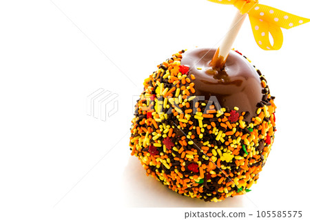 Hand dipped caramel apple covered with multi color sprinkles. Hand dipped caramel apple covered with multi color sprinkles. 105585575