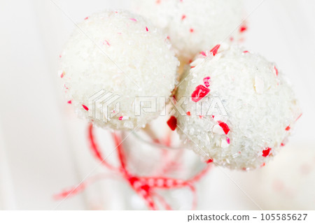 Peppermint chocolate cake pops dipped in white chocolate and candy cane bits. 105585627