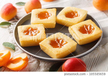 Tasty summer soft cookies Cuor di tenerezza with apricot jam close-up on a plate. Horizontal 105585659