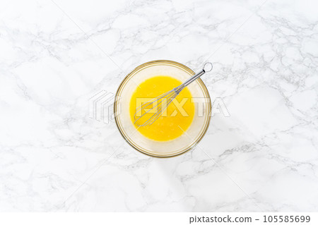 Flat lay. Mixing ingredients in a large glass mixing bowl to bake chocolate peppermint cupcakes. 105585699