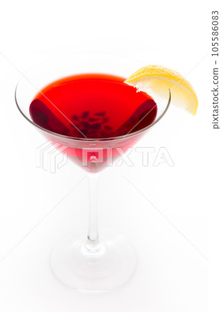 Pomegranate cosmo cocktail with lemon as a garnish. Pomegranate cosmo cocktail with lemon as a garnish. 105586083