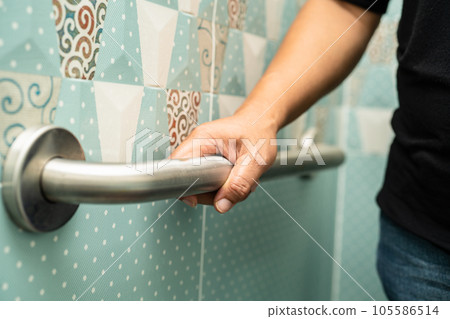 Asian elderly woman use bathroom handle security in toilet, healthy strong medical concept. Asian elderly woman use bathroom handle security in toilet, healthy strong medical concept. 105586514