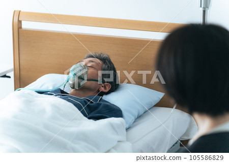 A woman watching over a hospital patient 105586829