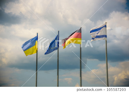 The flag of the European Union and flags of Ukraine, Israel, Germany flutter in the wind in different directions against the blue sky. Bottom side view 105587203