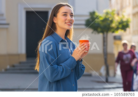 Lovely woman enjoying drinking morning aroma coffee hot drink relaxing taking a break in city street Lovely woman enjoying drinking morning aroma coffee hot drink relaxing taking a break in city street 105589703