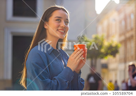 Lovely woman enjoying drinking morning aroma coffee hot drink relaxing taking a break in city street 105589704
