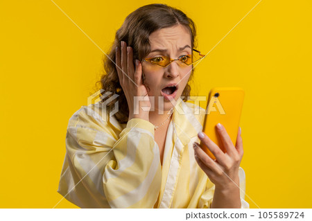 Woman use smartphone typing browsing loses becoming surprised sudden lottery result bad fortune Woman use smartphone typing browsing loses becoming surprised sudden lottery result bad fortune 105589724