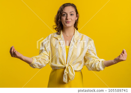 Young woman breathes deeply, eyes closed, meditating with concentrated thoughts, peaceful mind 105589741