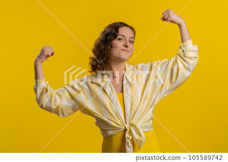 Woman showing biceps and looking confident, feeling power strength to fight for rights, success win 105589742