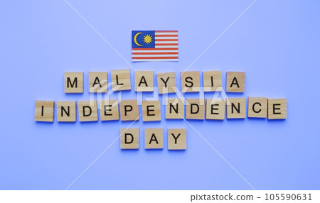 August 31, Malaysia Independence Day, Malaysia National Day, flag of Malaysia, minimalistic banner with wooden letters on a blue background August 31, Malaysia Independence Day, Malaysia National Day, flag of Malaysia, minimalistic banner with wooden letters on a blue background 105590631