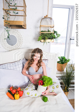 healthy nutrition and pregnancy. pregnant woman's belly and vegetable salad healthy nutrition and pregnancy. pregnant woman's belly and vegetable salad 105592657