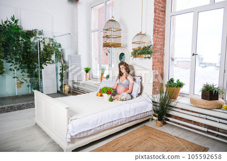 healthy nutrition and pregnancy. pregnant woman's belly and vegetable salad healthy nutrition and pregnancy. pregnant woman's belly and vegetable salad 105592658