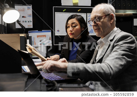 Business invoicing management executives comparing accountancy market data analysis paperwork. Senior manager and asian collegue collaborating in archival depository office Business invoicing management executives comparing accountancy market data analysis paperwork. Senior manager and asian collegue collaborating in archival depository office 105592859