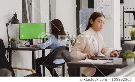 Business manager analyzing greenscreen display on pc, chekcing isolated copyspace on computer in coworking space. Employee using blank mockup template on screen, agency office. Business manager analyzing greenscreen display on pc, chekcing isolated copyspace on computer in coworking space. Employee using blank mockup template on screen, agency office. 105592863
