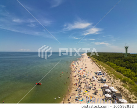 beach with forest and blue water, tourists on vacation, Jastarnia, Hel peninsula beach with forest and blue water, tourists on vacation, Jastarnia, Hel peninsula 105592938