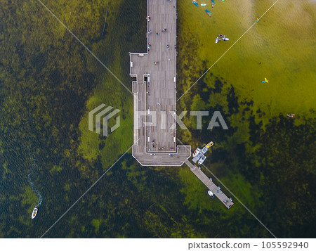 molo pier of Polish village Jastarnia, water of Baltic Sea, aerial drone view 105592940