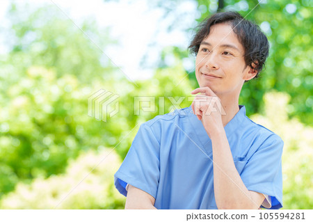 A man wearing a scrub thinking A man wearing a scrub thinking 105594281