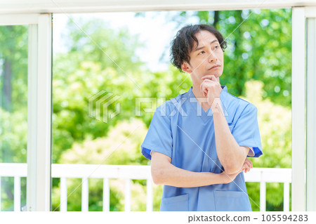 A man wearing a scrub thinking 105594283