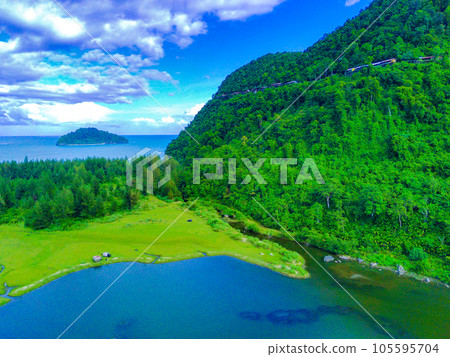 aerial footage of beautiful babah ie village with pond and savannah and pine trees, aceh jaya, Indonesia. 105595704