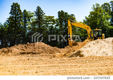 Image of a hydraulic excavator excavating earth and sand in a mountainous area | Image of residential land development | Image of destruction of nature | Construction image Image of a hydraulic excavator excavating earth and sand in a mountainous area | Image of residential land development | Image of destruction of nature | Construction image 105597685