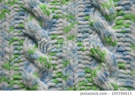 Blue and green Aran braid cable stitch knitting pattern background Blue and green Aran braid cable stitch knitting pattern background 105599815