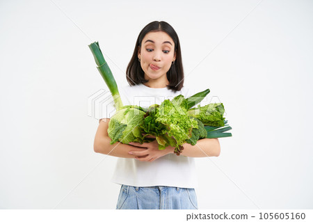 Image of korean girl vegetarian, holds raw vegetables, isolated on white background Image of korean girl vegetarian, holds raw vegetables, isolated on white background 105605160
