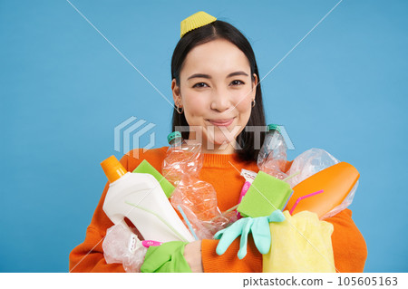 Portrait of smiling asian woman with plastic garbage, holding waste and looks happy, collects litter for recycling center, sustainable lifestyle concept Portrait of smiling asian woman with plastic garbage, holding waste and looks happy, collects litter for recycling center, sustainable lifestyle concept 105605163