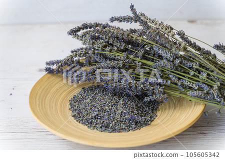 Dried lavender flowers on a wooden plate. Dried lavender flowers on a wooden plate. 105605342