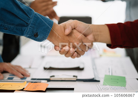 designer team shake hands confidently professional investor working with new startup project at an office meeting. 105606867
