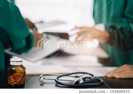 Medical team working on digital tablet healthcare doctor technology tablet using computer analyzed the results of medical reports, an online conference at the hospital. 105606935