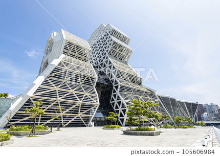 Low angle view of Kaohsiung Music Center in Taiwan. The white hexagonal building structure on the shore of Kaohsiung Port. Low angle view of Kaohsiung Music Center in Taiwan. The white hexagonal building structure on the shore of Kaohsiung Port. 105606984