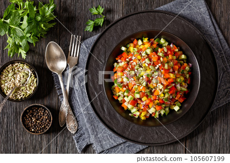 Israeli salad of finely diced veggies in bowl 105607199