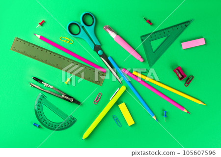 school supplies, rulers, pencils, buttons, pen, compasses, paper clips green background flat lay 105607596