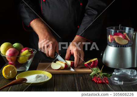 The chef prepares fruit jam from fresh apples. The cook cuts apples for chopping in a blender. Menu or recipe idea for hotel or restaurant The chef prepares fruit jam from fresh apples. The cook cuts apples for chopping in a blender. Menu or recipe idea for hotel or restaurant 105608226