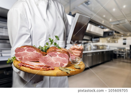 The chef shows sliced ham. The chef shows sliced ham. 105609705